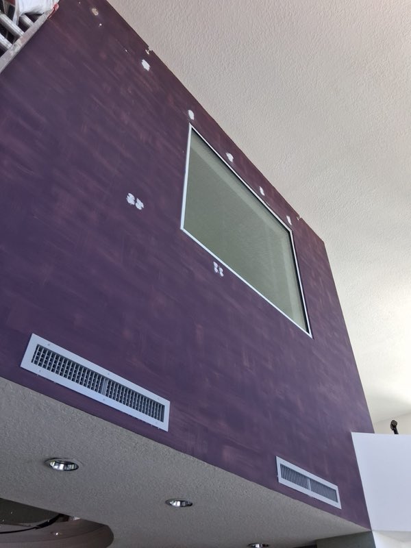 Textured accent wall prepped for coverage