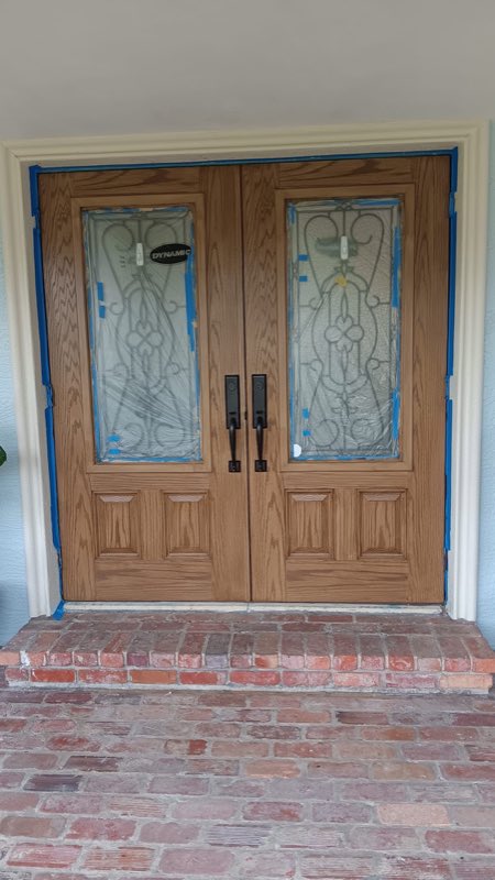 Carved double doors masked and ready to refinish